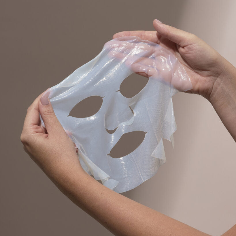 Person holding a clear silicone on a neutral background