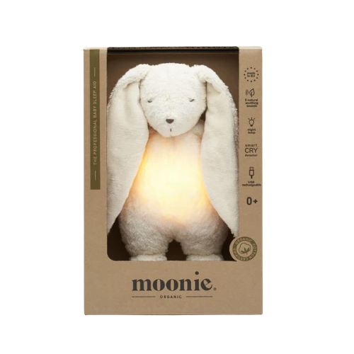 Moonie organic plush toy with a light inside its ears in a cardboard box on a white background