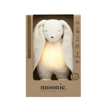 Moonie organic plush toy with a light inside its ears in a cardboard box on a white background