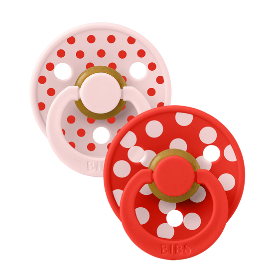 Two dummies from bibs with polka dots red and pink
