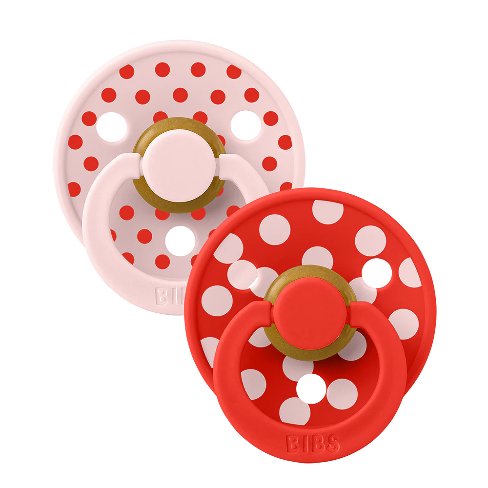Two dummies from bibs with polka dots red and pink