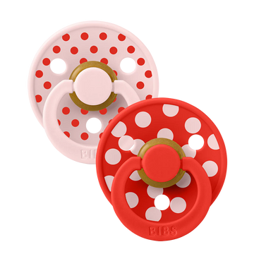 Two dummies from bibs with polka dots red and pink