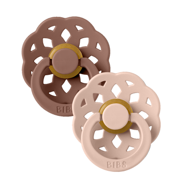 Set of two BIBS Boheme pacifiers featuring blush and woodchuck glow colors, flower-style silicone shields—premium baby soothers for newborns and infants. Round, size one.