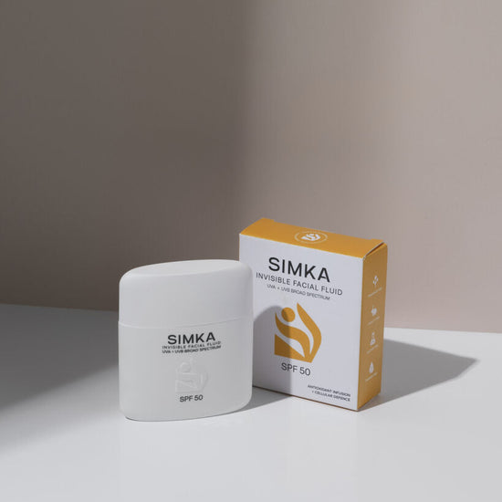 Simka sunscreen and packaging on a neutral background