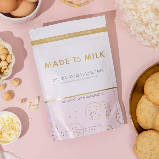 Made to Milk cookie packet mix on a pink background with cookies and ingredients.