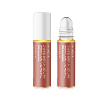 Two essential oil roller bottles with purple innove love essential oil roll on