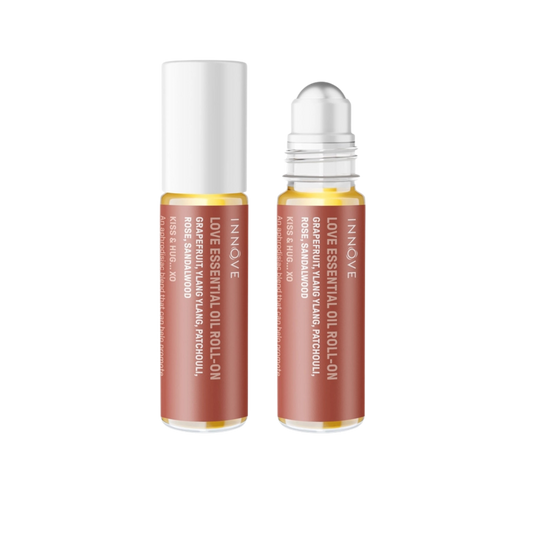 Two essential oil roller bottles with purple innove love essential oil roll on