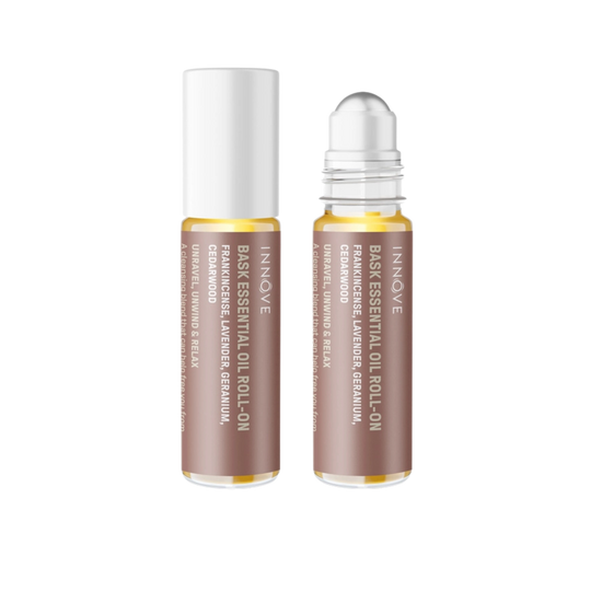 Two essential oil roller bottles with brown innove bask essential oil roll on