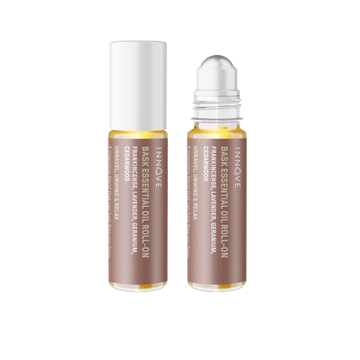 Two essential oil roller bottles with brown innove bask essential oil roll on