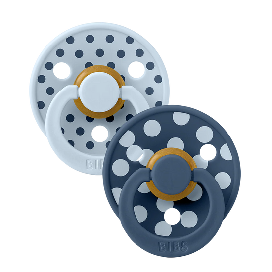 Two baby pacifiers with polka dot design navy blue and light blue