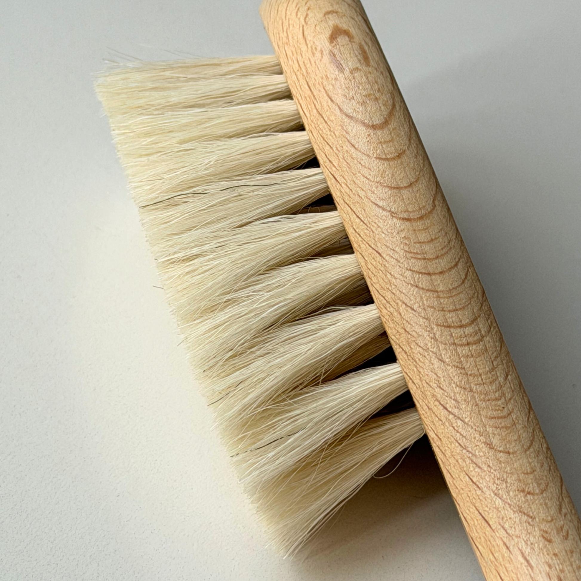 Baby wooden brush on grey background