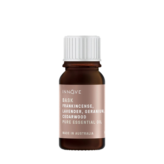 10mls Essential oil bottle named Bask with frankincense, lavender, geranium and cedarwood with a white cap on a Transparent background