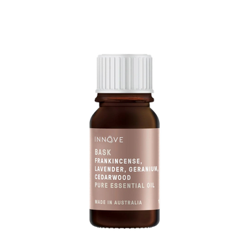 10mls Essential oil bottle named Bask with frankincense, lavender, geranium and cedarwood with a white cap on a Transparent background