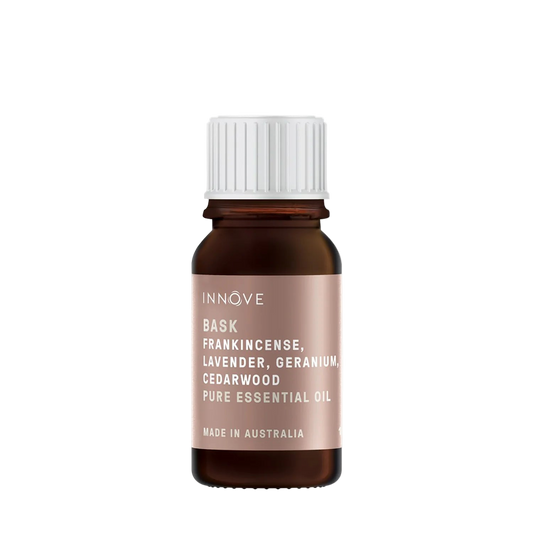 10mls Essential oil bottle named Bask with frankincense, lavender, geranium and cedarwood with a white cap on a Transparent background