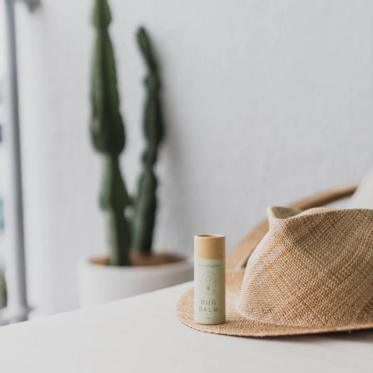 Bug balm tube on a woven hat with a cactus plant. 