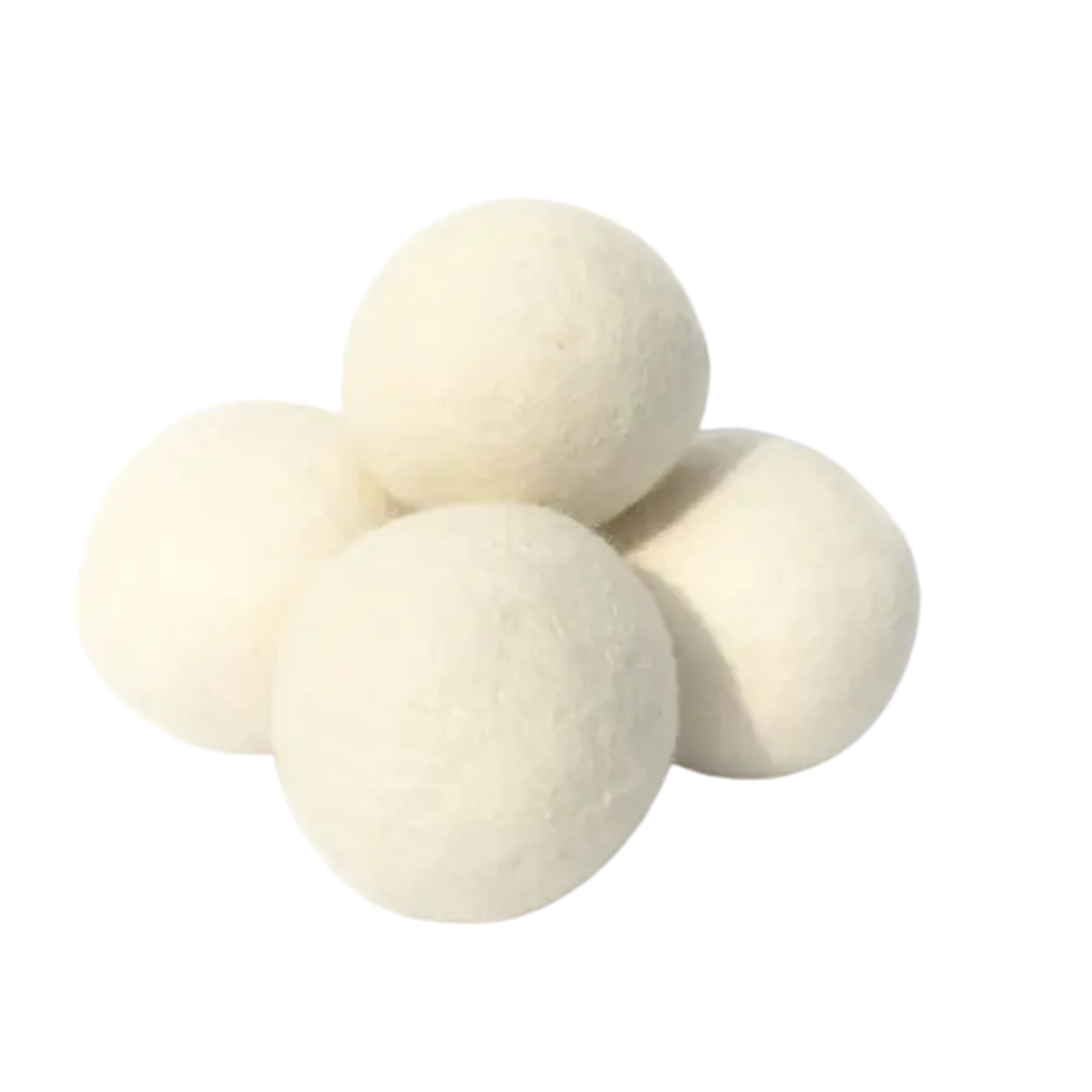 Four white dryer balls on a white background