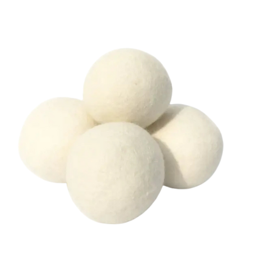 Four white dryer balls on a white background