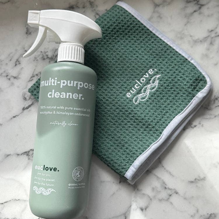 Green multi-purpose cleaner bottle and green cloth on a marble surface with 'euclove' branding.