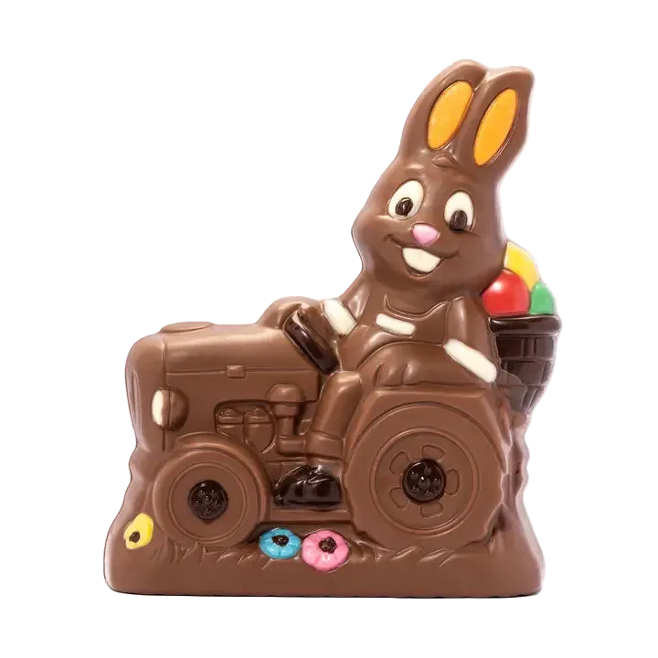 Chocolate bunny riding a tractor with colorful candies on a white background