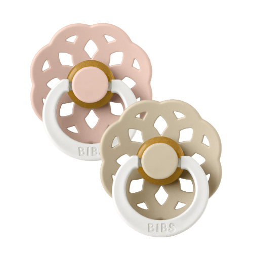 Set of two BIBS Boheme pacifiers featuring blush and vanilla colours, flower-style silicone shields, and white ring handles—premium baby soothers for newborns and infants. Glow in the dark, round, size one.