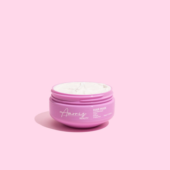 Pink amoris hair mask jar on a pink background
