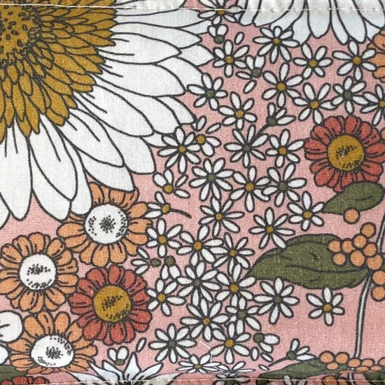 Lavender eye pillow rectangle Fabric with pink base colour white flowers, peach flowers, green leaves, red flowers, mustard pollen and blue pollen floral pattern