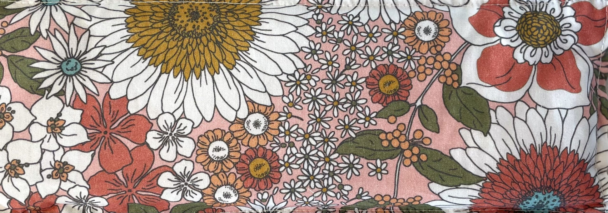 Lavender eye pillow rectangle Fabric with pink base colour white flowers, peach flowers, green leaves, red flowers, mustard pollen and blue pollen floral pattern