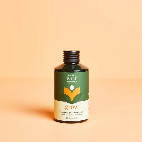 Bottle of 'We The Wild' Grow Concentrate Organic Liquid Plant Food on a beige background