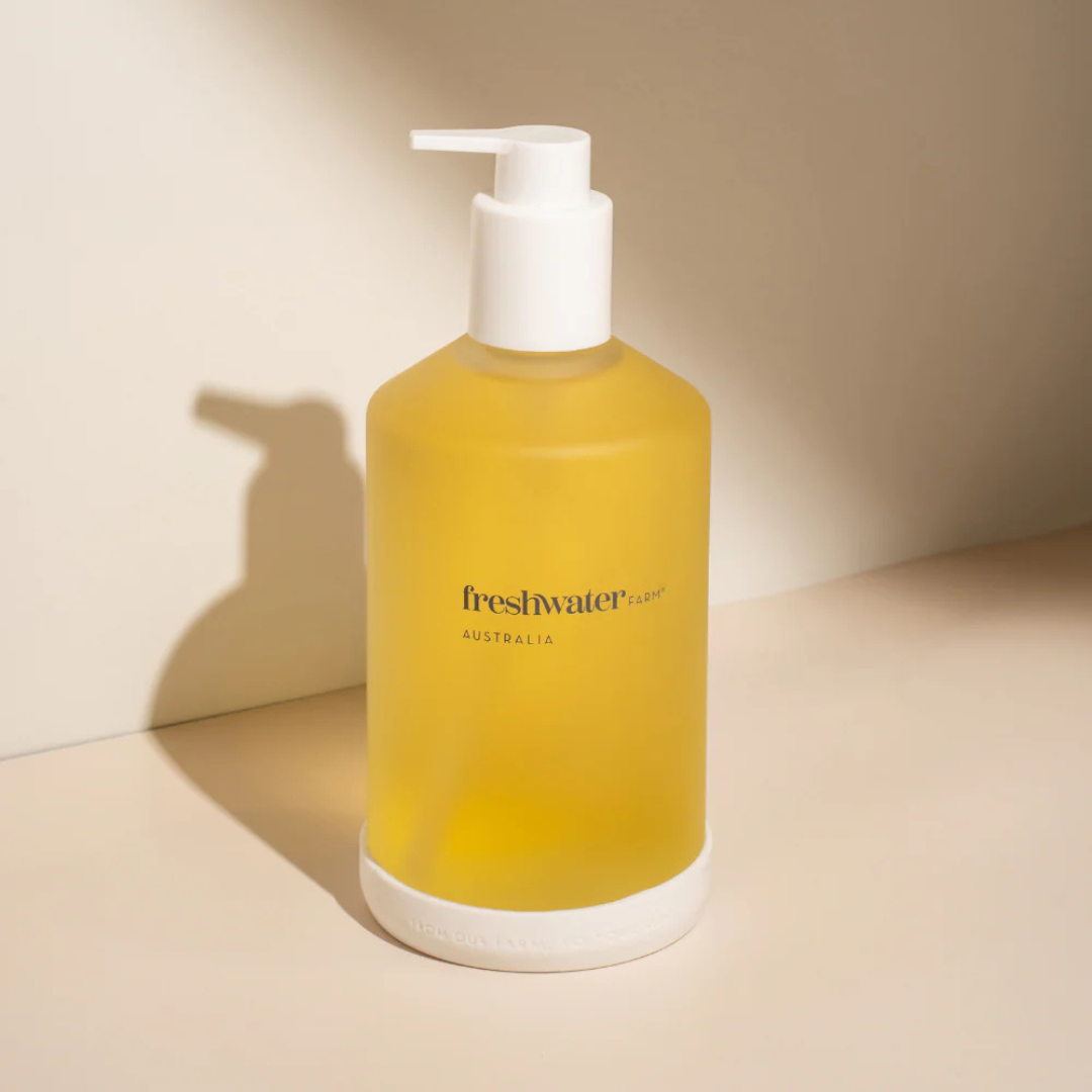 Yellow bottle with pump dispenser on a beige background