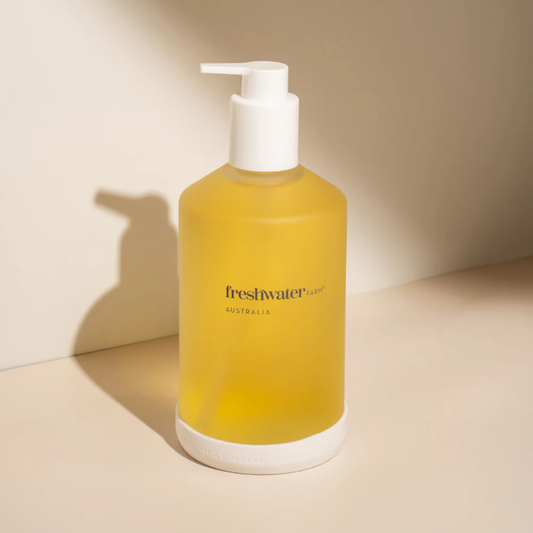 Yellow bottle with pump dispenser on a beige background