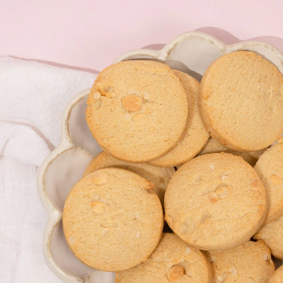 made to milk Cookies in a decorative bowl on a pink background