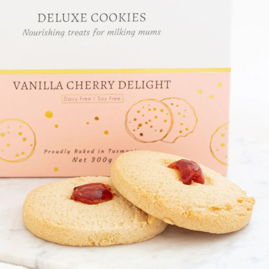 Vanilla cherry delight cookies with a pink box in the background made to milk