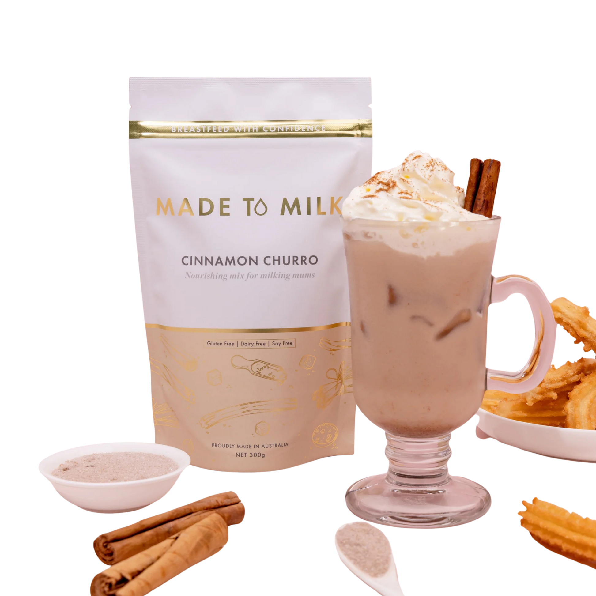 Made to Milk cinnamon churro flavor package with a glass of hot chocolate, whipped cream, and cinnamon sticks.