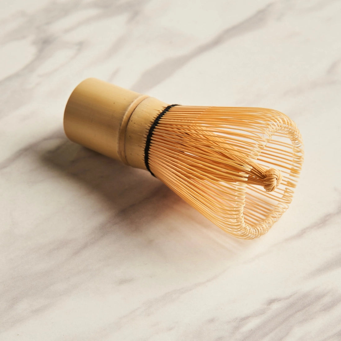 Bamboo matcha whisk on a marble background