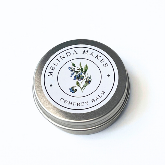 Tin of Melinda Makes Comfrey Balm on a white background