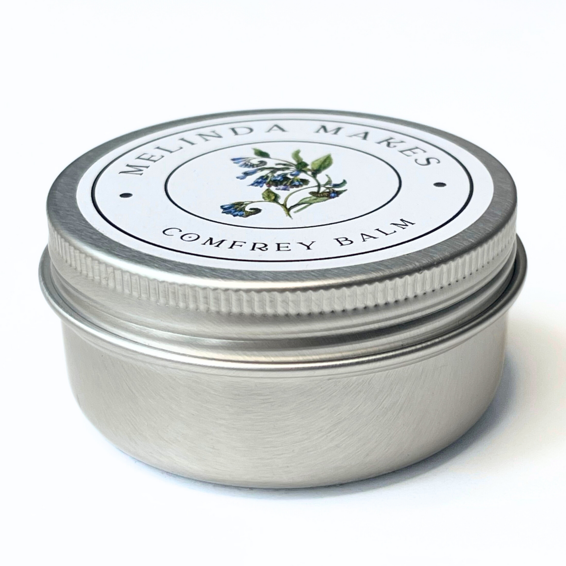 Comfrey balm jar with 'Melinda Makes' label on a white background
