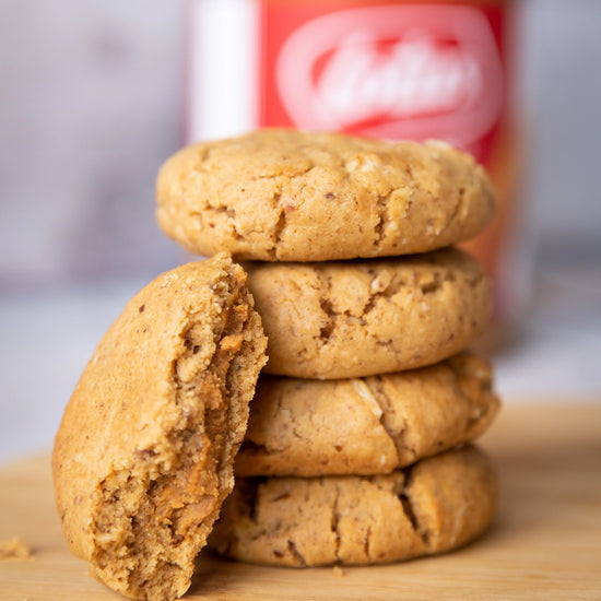 Stack of lactation biscoff cookies with a blurred container of biscoff in the background