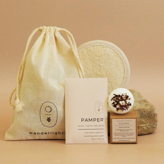 Pamper product set with drawstring bag, soap, and boxes.