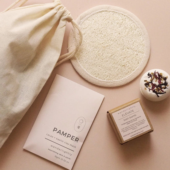 A gentle pause wrapped in ritual. Let the Pamper Clay Mask sweep away impurities and awaken your skin’s natural glow, while the loofah mitt softly renews and smooths. Sink into the botanicals of your chosen bath bomb, uplifting or indulgent, and drift into a moment of calm where body, mind, and spirit are restored. on pink background
