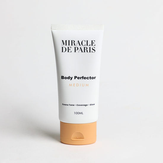 Tube of Medium Miracle de Paris Body Perfector on a light gray background