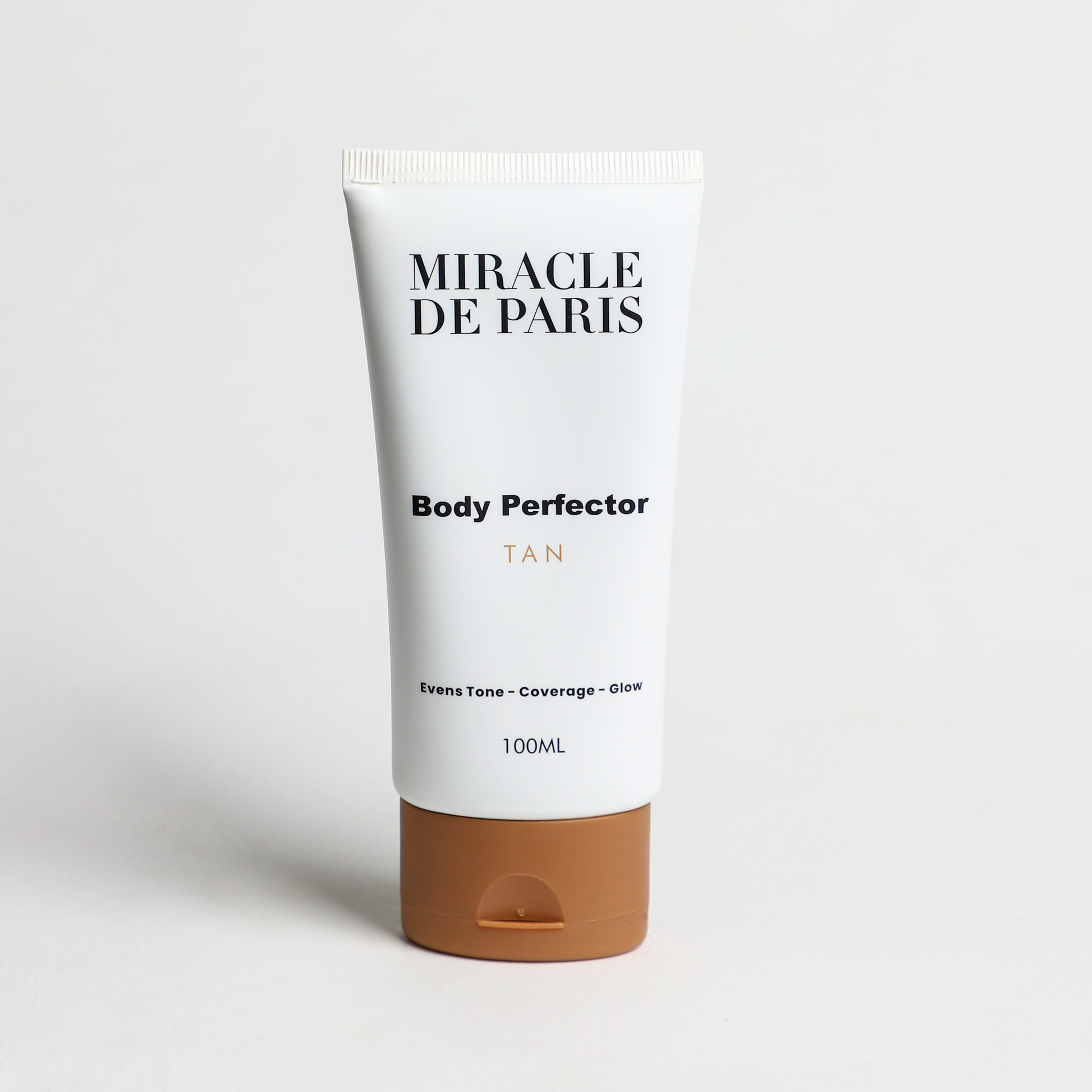 Tube of Tan Miracle de Paris Body Perfector on a light gray background