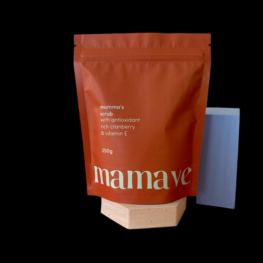 Red packaging of 'mamave' Mumma's Scrub on an surface with resealable bag  