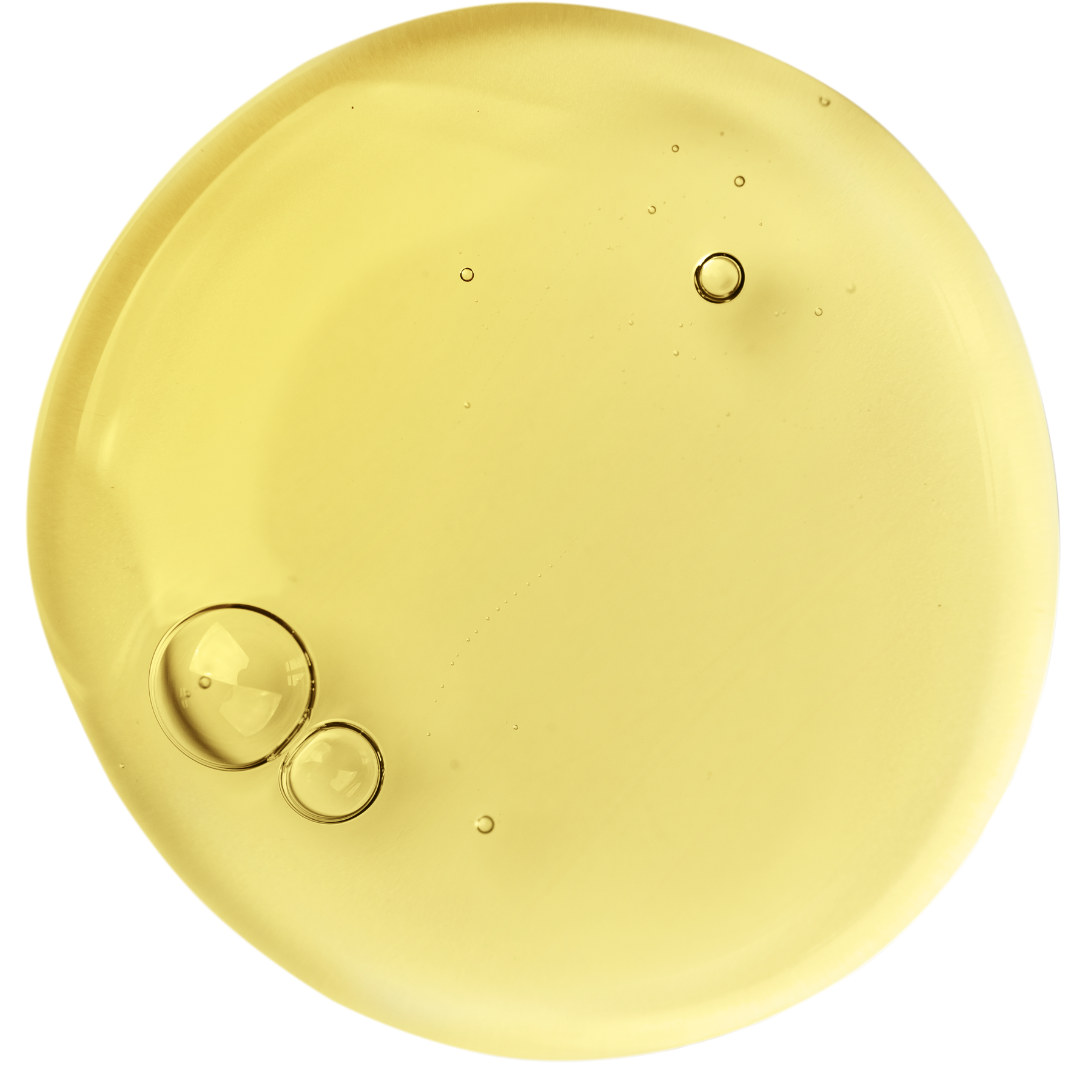 Round yellow swatch of oil with bubbles on a white background