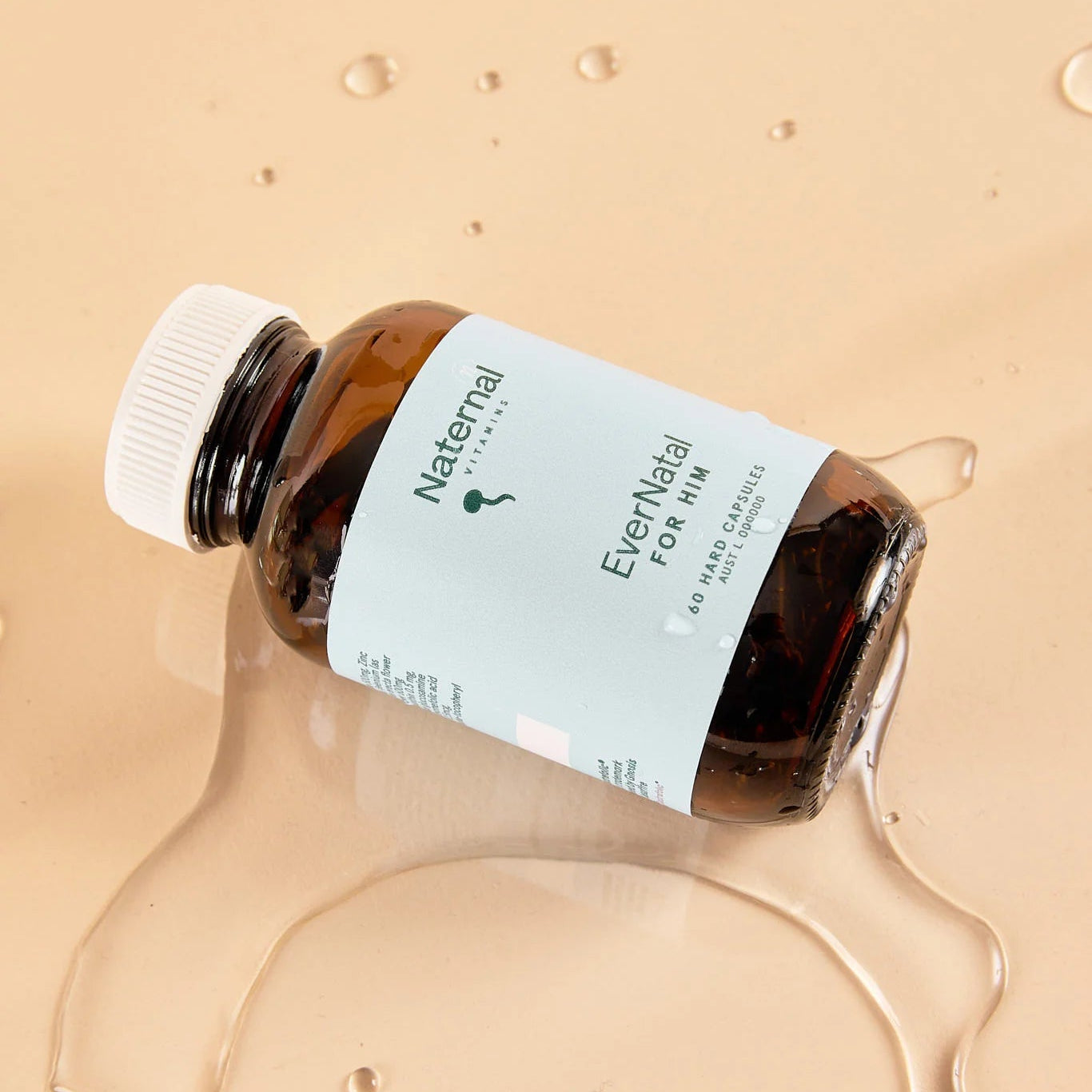 Bottle of Naternal EverNavel on a beige background with product residue.