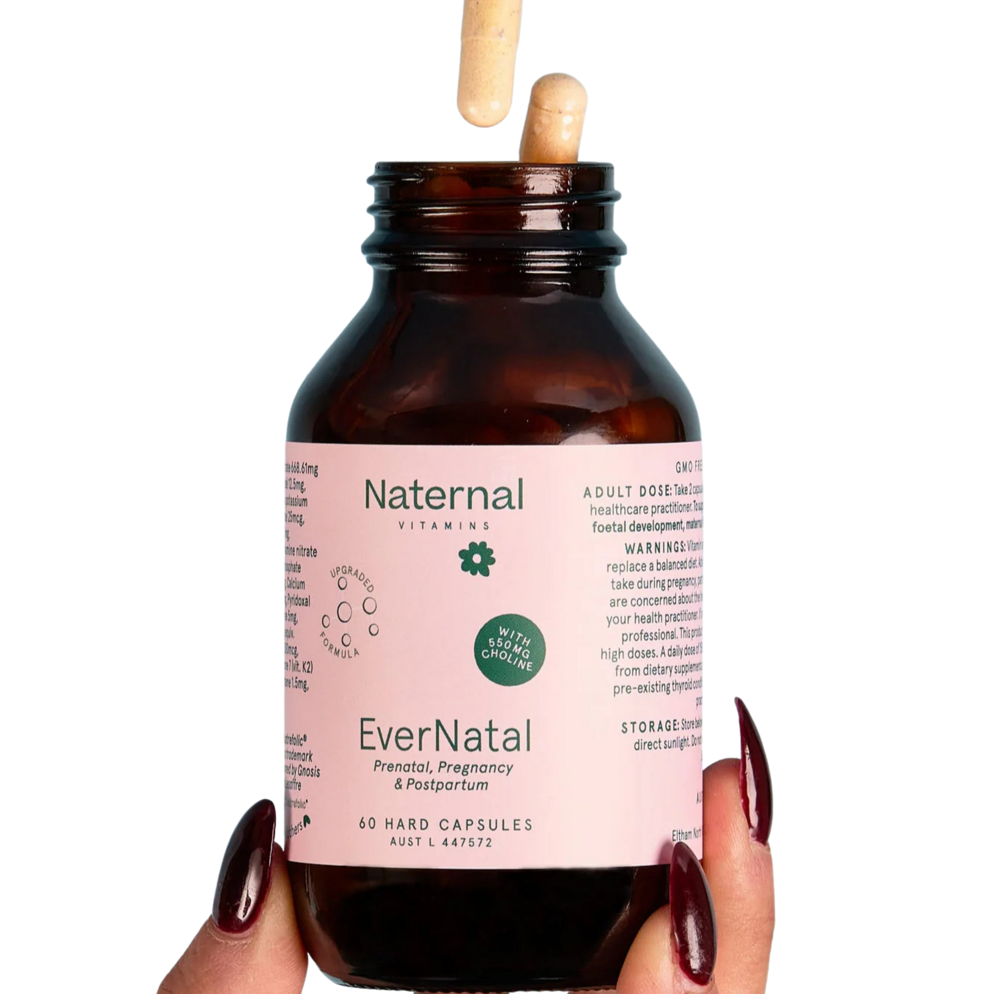 Bottle of Naternal EverNatal prenatal, pregnancy & postpartum vitamins held by a hand with dark nail polish 