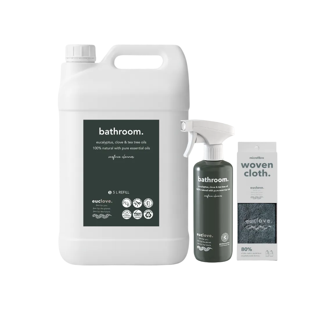 Bathroom cleaning products including a large refill container, spray bottle, and woven cloth .