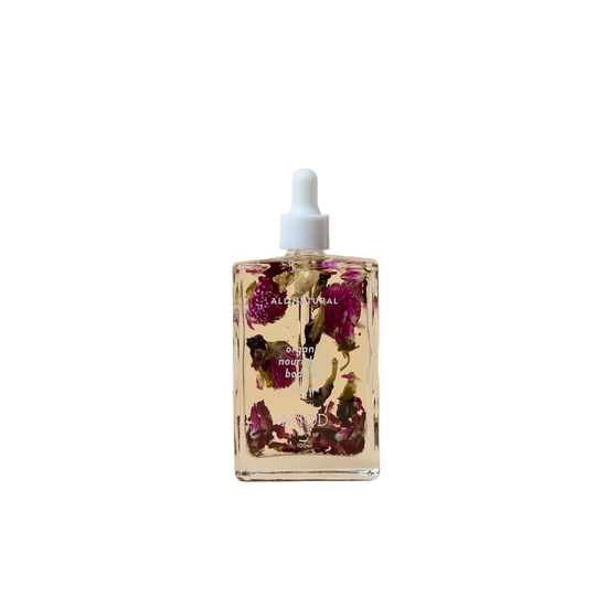 Bottle of floral oil with dried flowers on organic nourishing body oil 