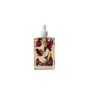 Bottle of floral oil with dried flowers on organic nourishing body oil 