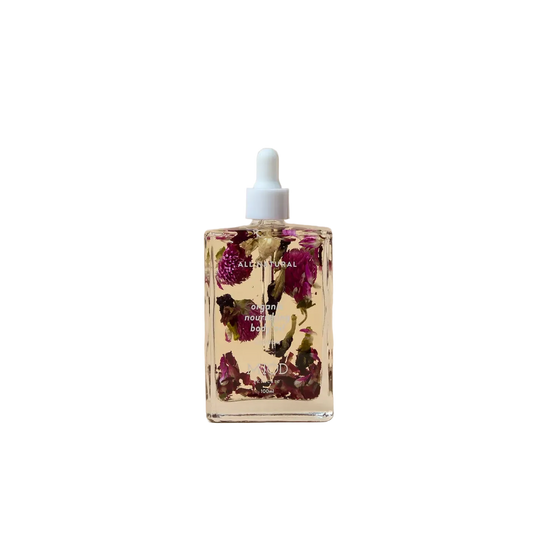 Bottle of floral oil with dried flowers on organic nourishing body oil 