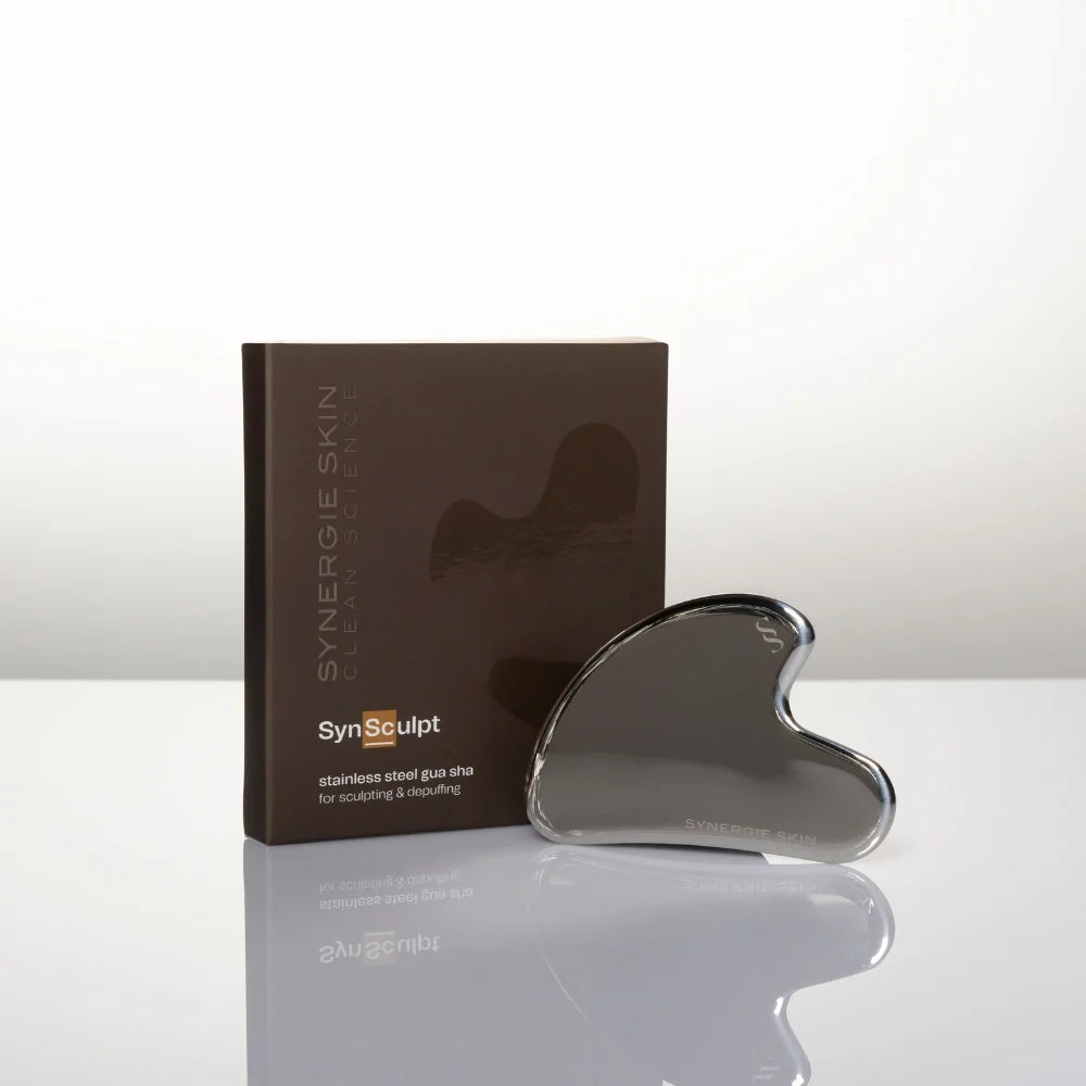 Gua Sha tool with packaging on a white background